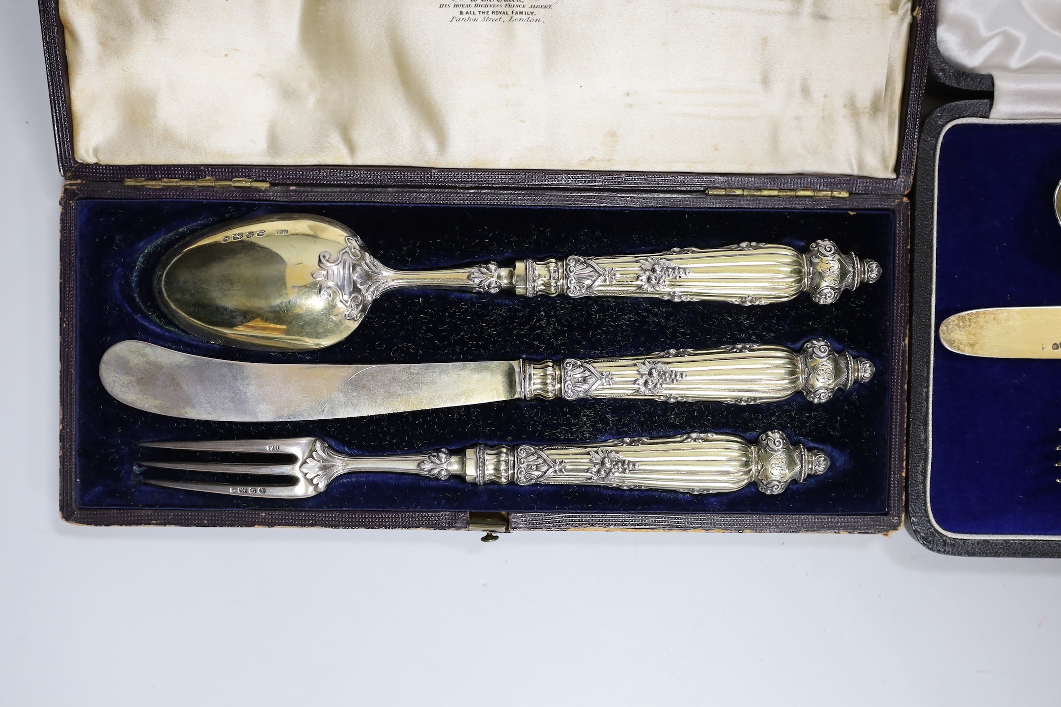 A cased George IV silver gilt christening trio (spoon, knife and fork) by Ely & Fearn, London, 1823 and one other cased Victorian parcel silver gilt trio, Francis Higgins, London, 1848/9.